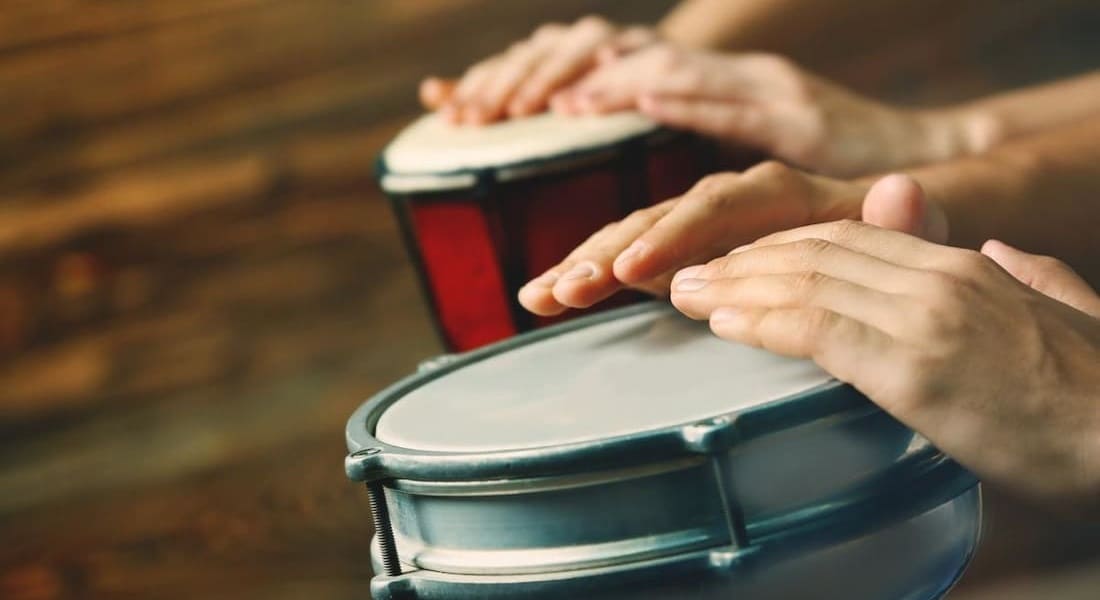 2 People playing plastic djembes