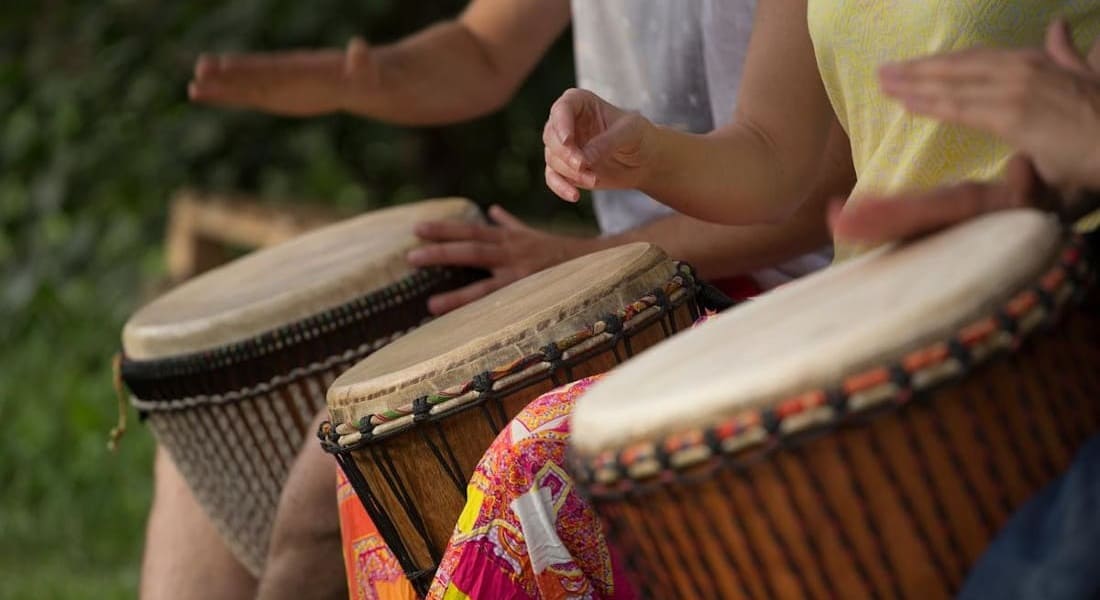 3 People playing djembes