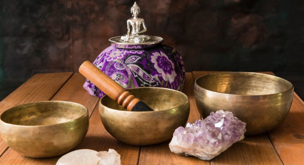 3 Tibetan bowls with a Buddha statue