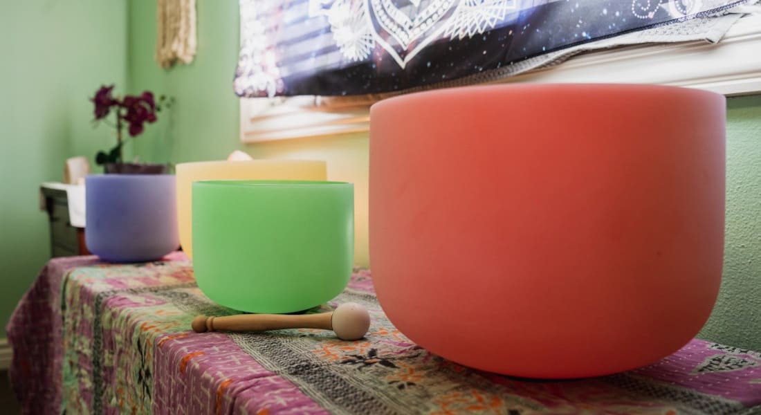 Four Tibetan quartz crystal singing bowls on a cabinet