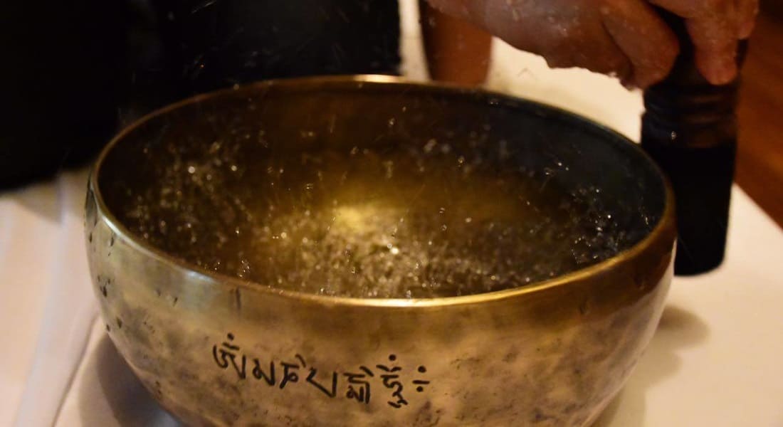 A Full Moon singing bowl filled with water