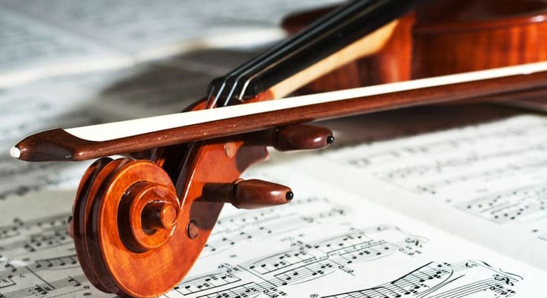 A violin placed on a sheet of music