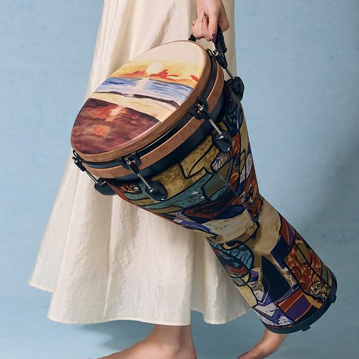 Beach djembe carried by a female musician