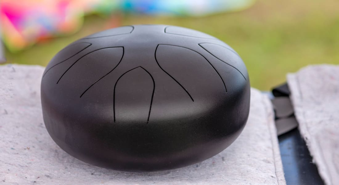 A black tongue drum on a rug
