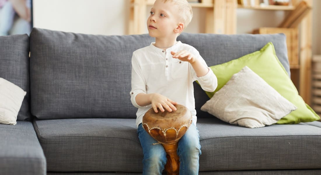 Blond child with a djembe