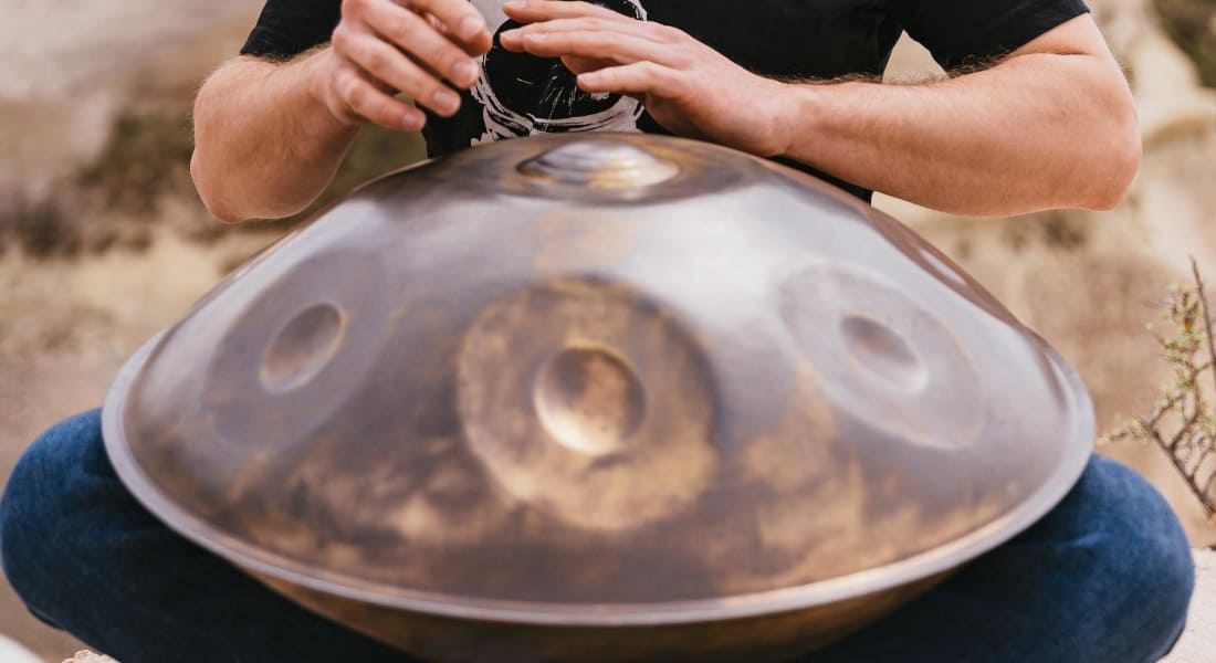Close-up of a handpan player with their hands