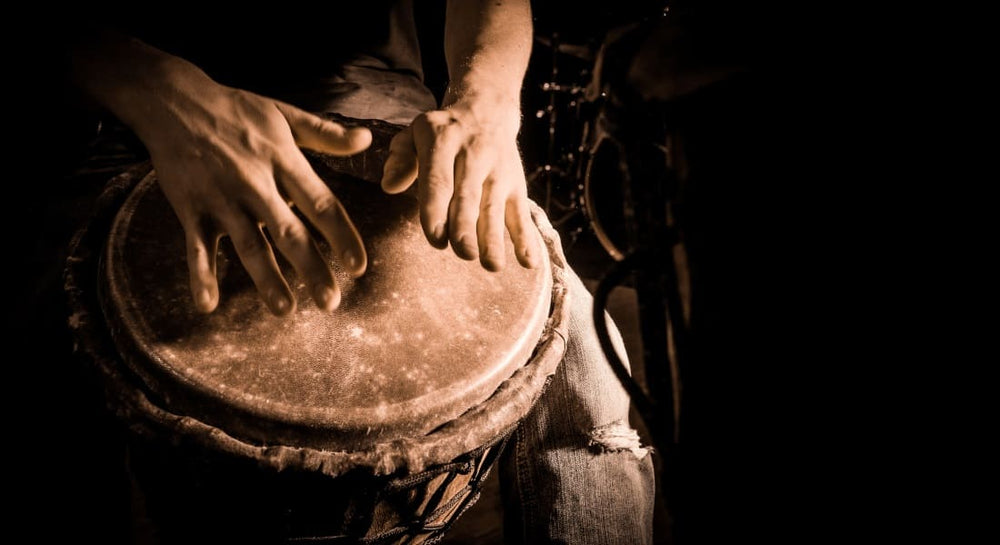 Close-up of hands playing a djembe