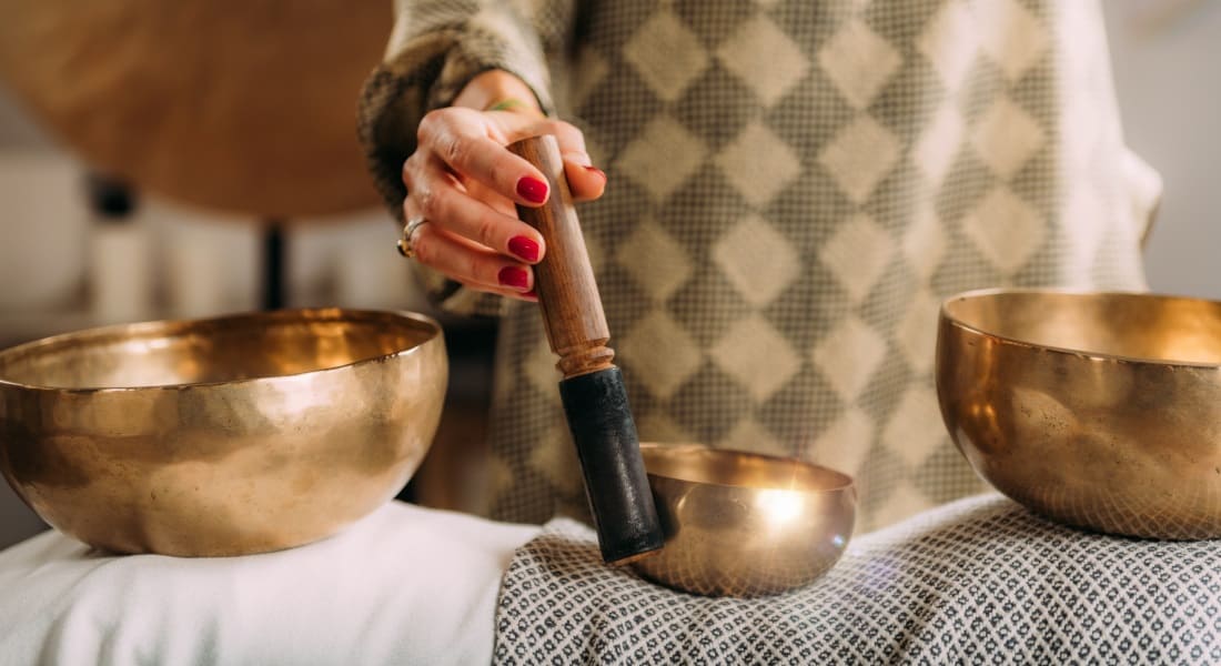 Close-up of someone performing a sound massage with singing bowls