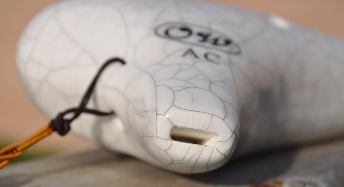Close-up of the mouthpiece of a white ocarina