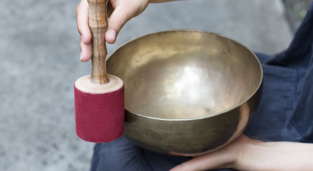 Close-up of a person rubbing a singing bowl