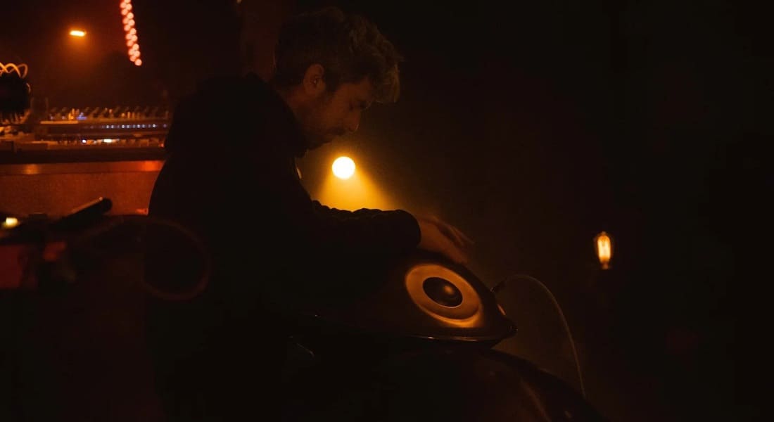 Connor Shafran playing on stage with a handpan