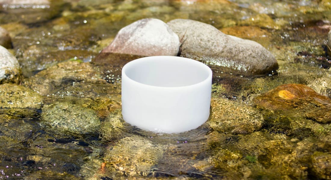 A crystal singing bowl in a stream