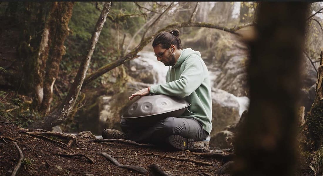 A handpan percussionist in the forest