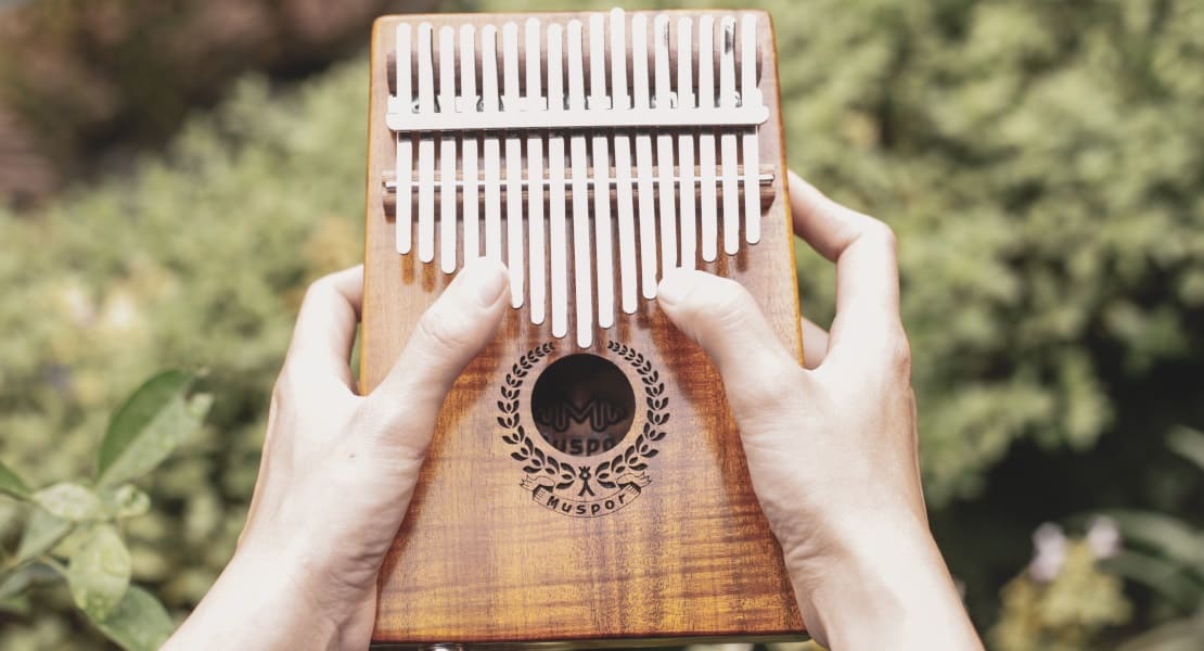 A kalimba with a sound hole held between two hands