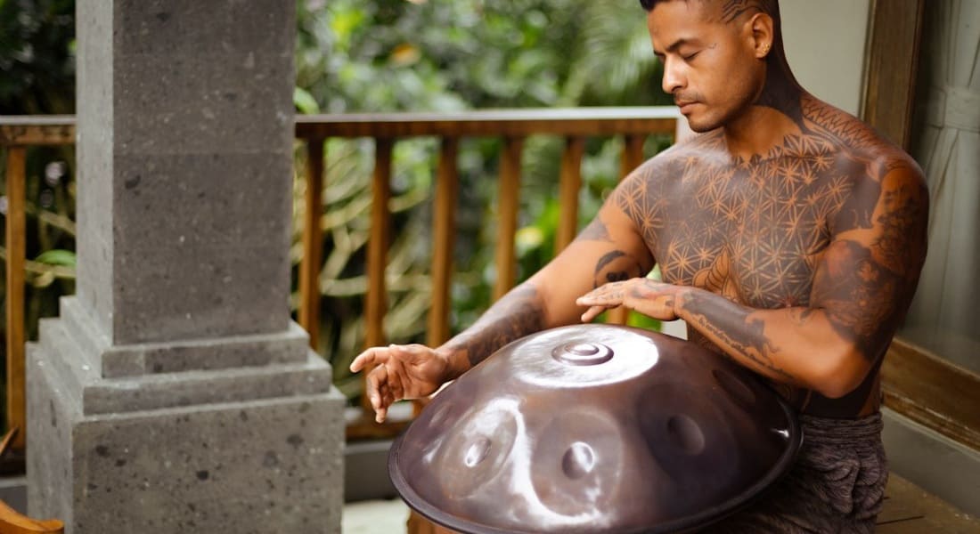 A man harmonizing his chakras with a handpan