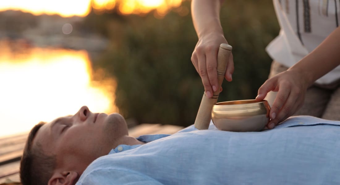 A man getting a massage with a singing bowl