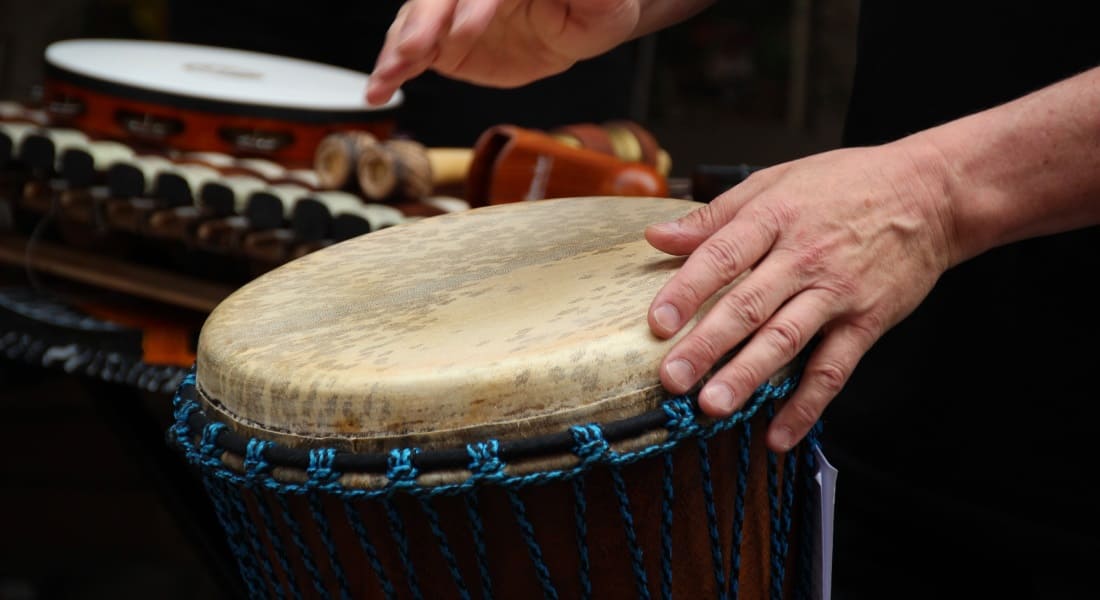 A musician playing a small djembe