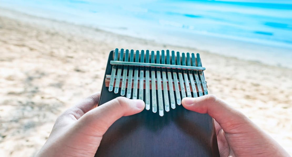 Point-of-view shot of a kalimba player on the beach