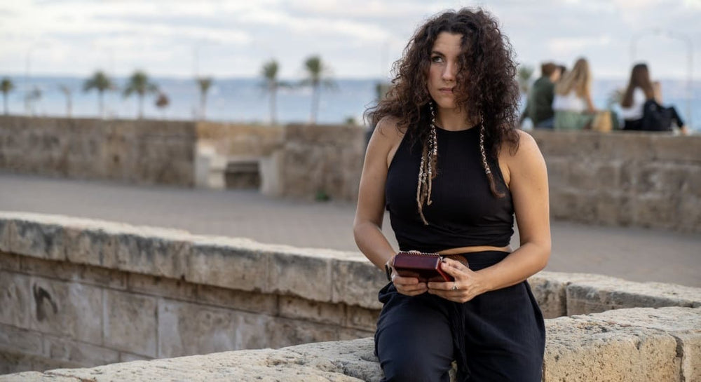 A pensive woman with a kalimba in the street