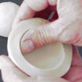 Shaping clay half-spheres into bowls