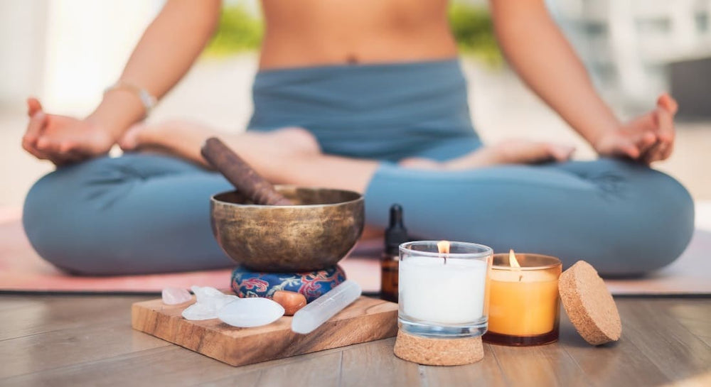 A Tibetan singing bowl on a cushion with candles