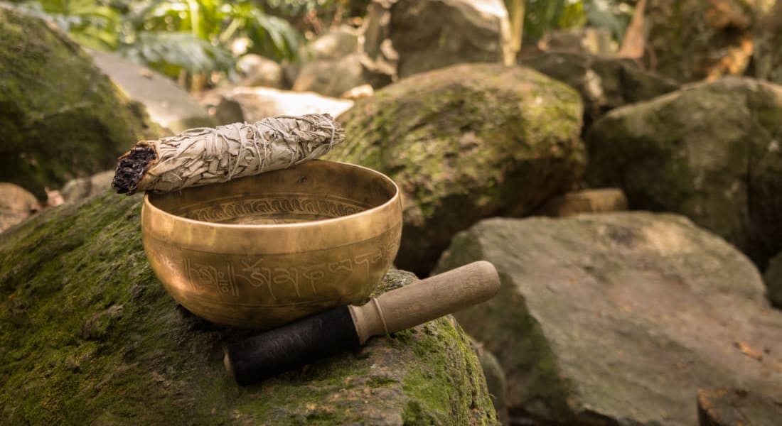 A Tibetan singing bowl with an incense stick placed on top