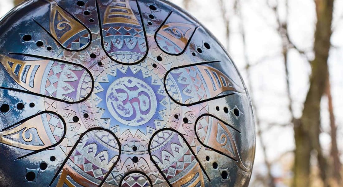 A tongue drum with an Om symbol engraved in Sanskrit