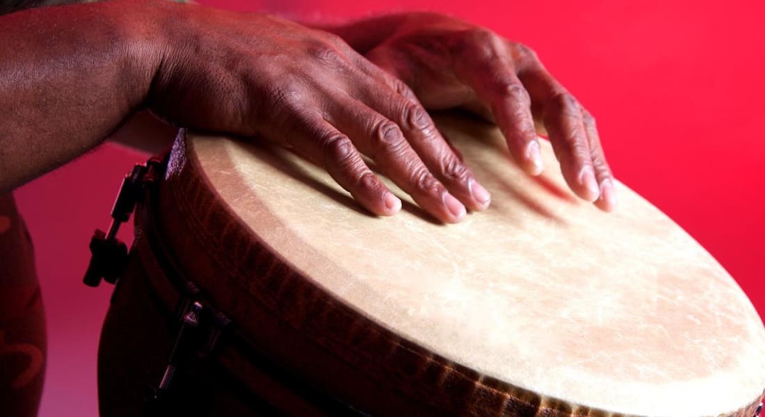 Two hands on a djembe skin