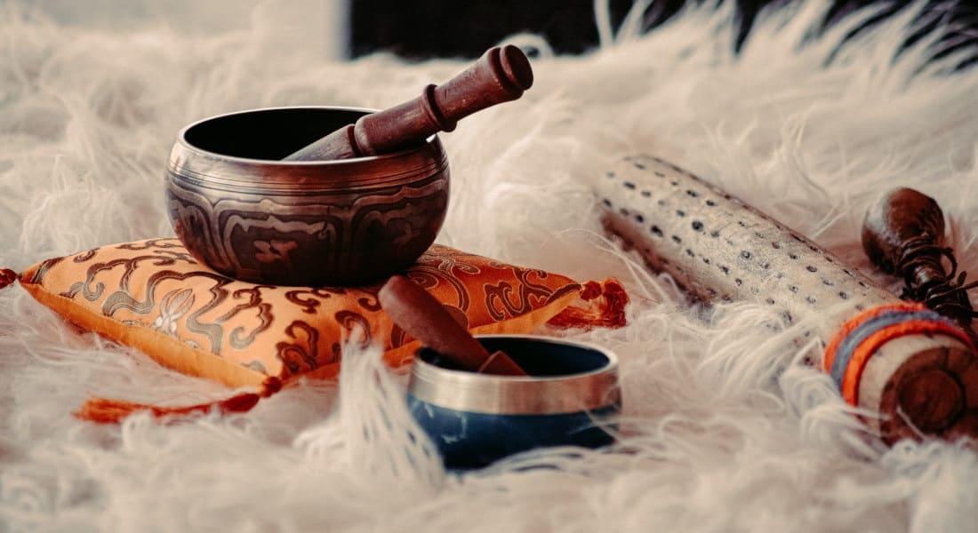 Two Tibetan bowls on a blanket.