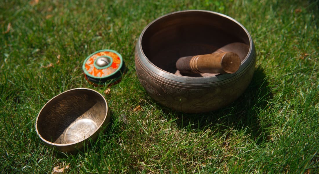 Two Tibetan singing bowls on the grass