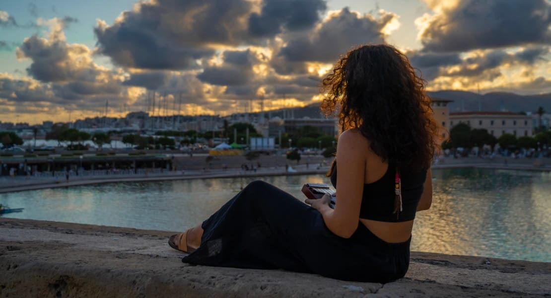 A woman seen from behind playing the kalimba