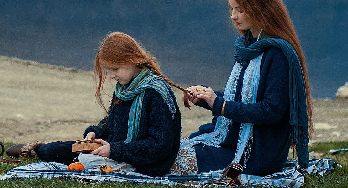 Woman and her daughter playing a kalimba