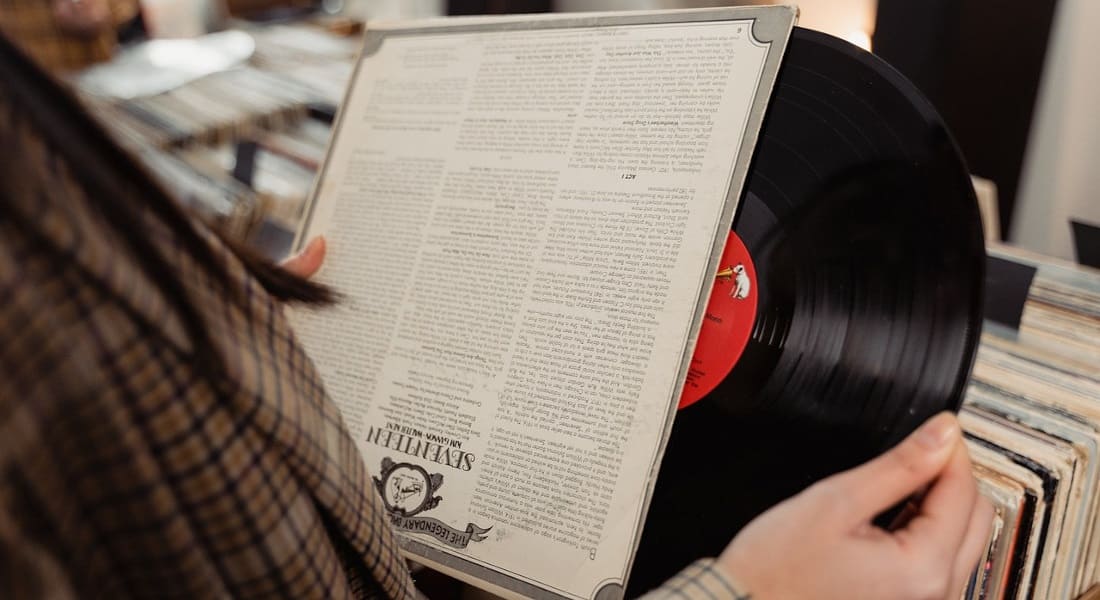 A woman looking at a vinyl record