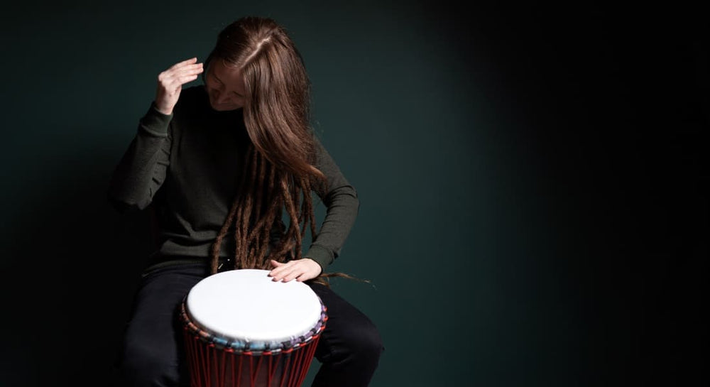A woman playing a percussion instrument