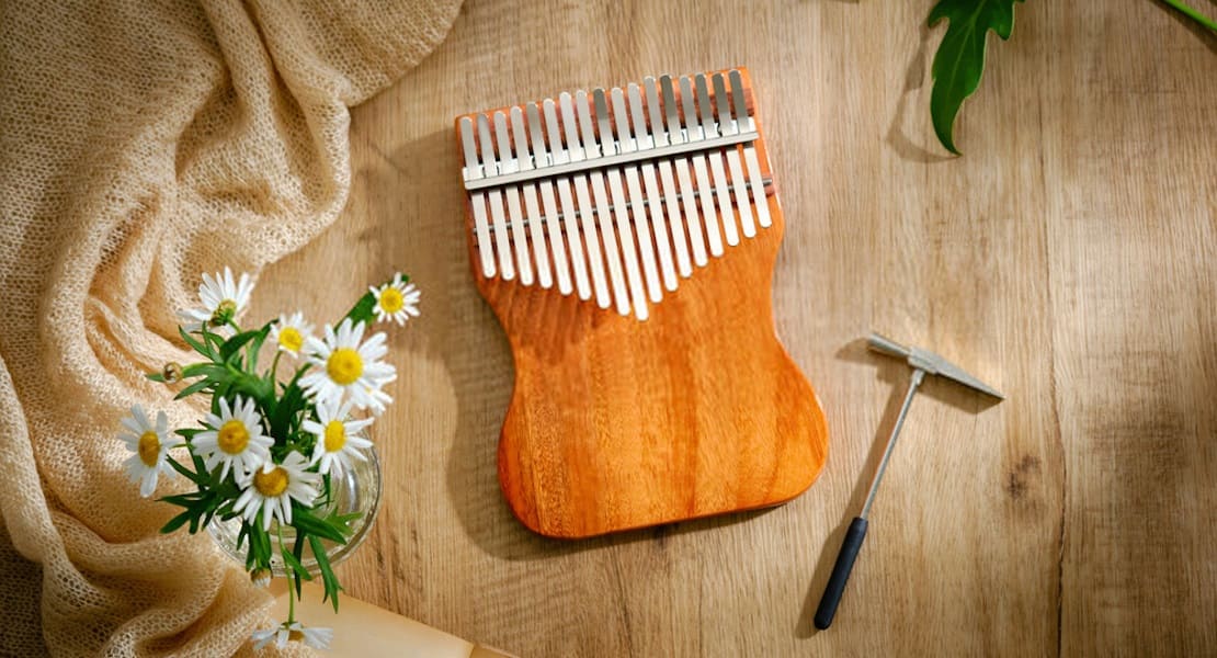 A wooden kalimba without a resonance box placed on a table