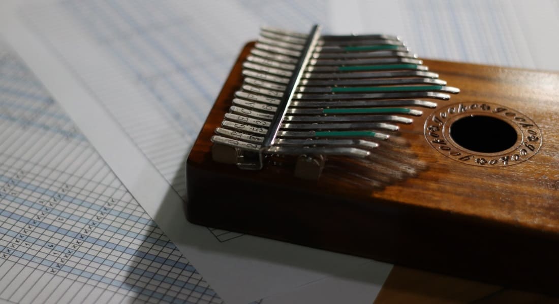 A Gecko kalimba placed on sheet music