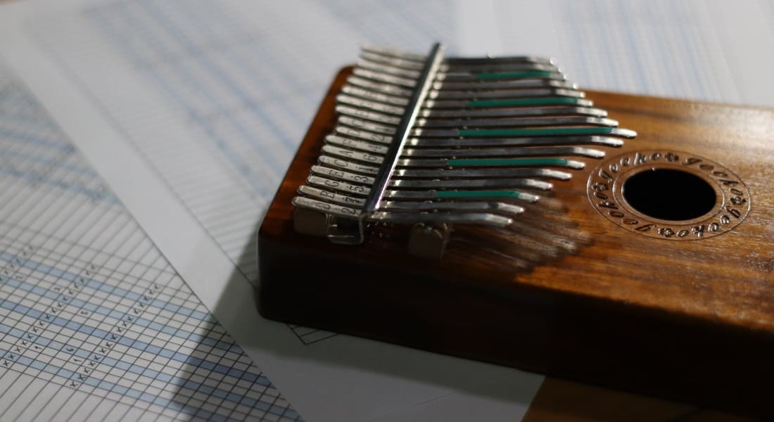 A kalimba resting on tablature sheets