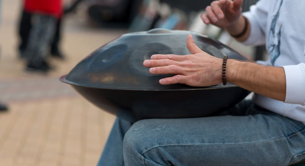 A man playing the handpan during a concert