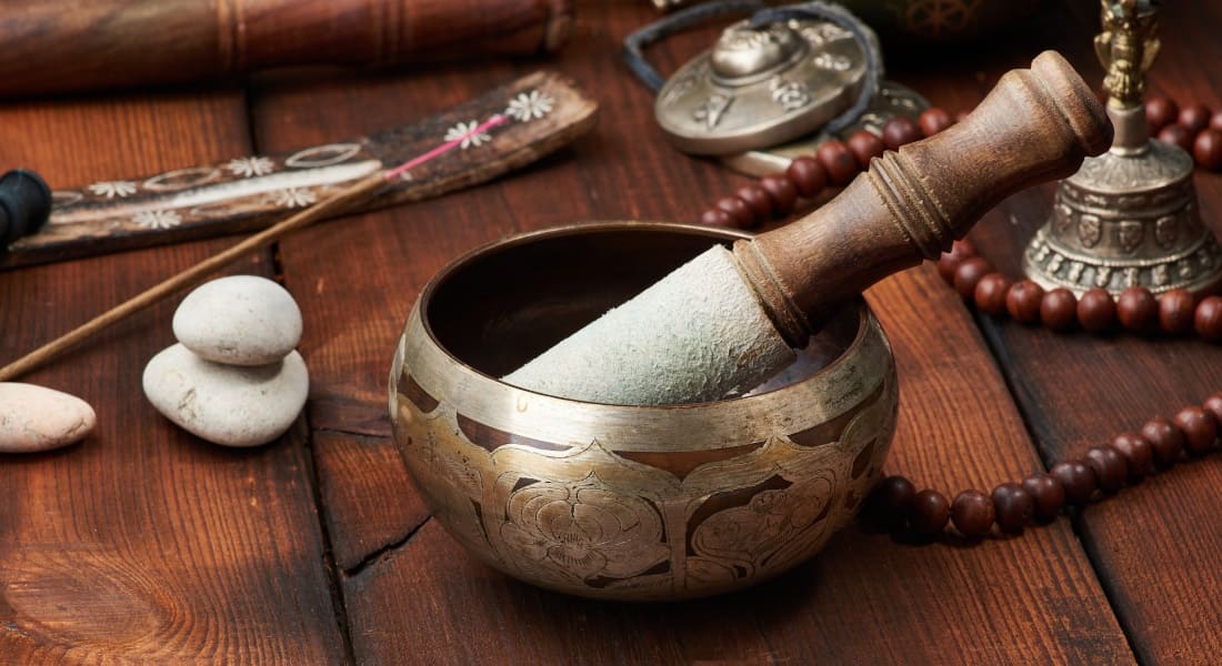 A singing bowl placed on a wooden table