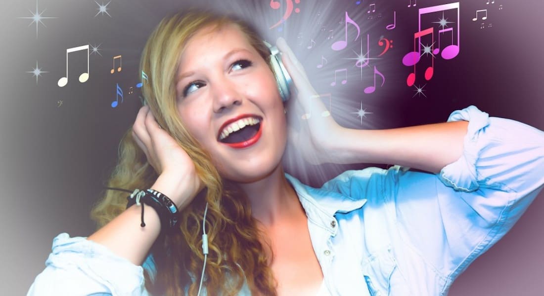 A woman singing with headphones