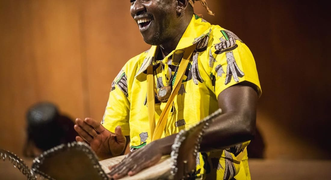 A musician playing at a djembé concert