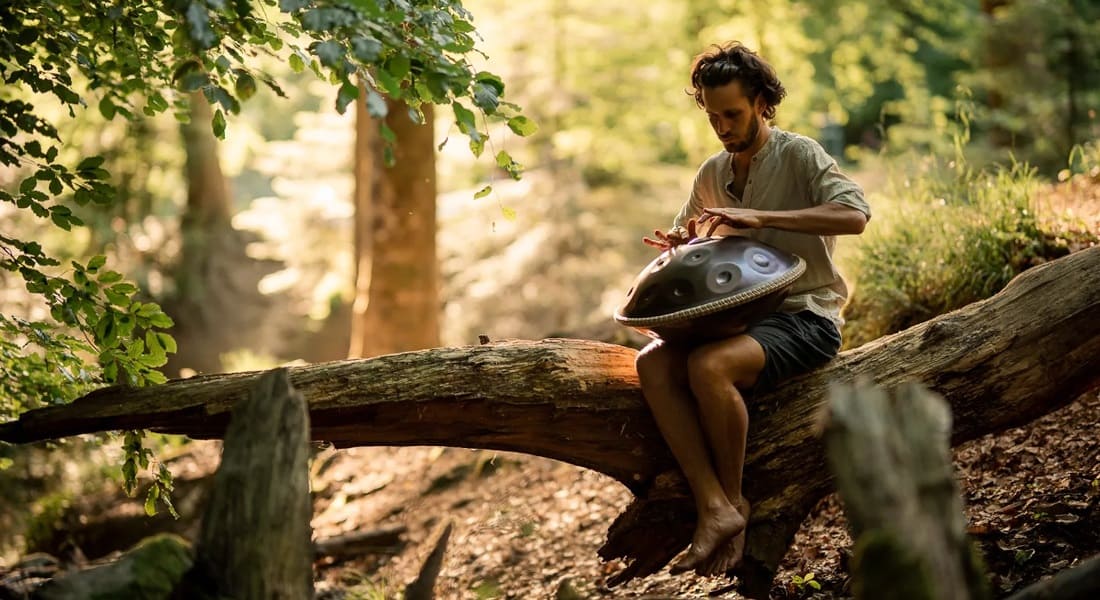 Alexander Mercks playing handpan in a tree