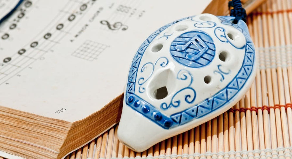 An 8-hole ocarina with a sheet music book