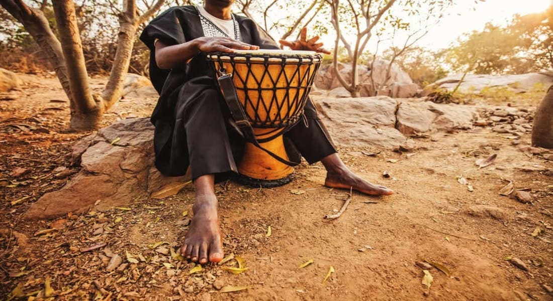 An African playing the djembe
