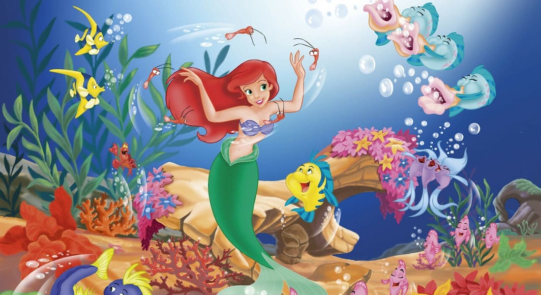Ariel in the ocean with fish swimming