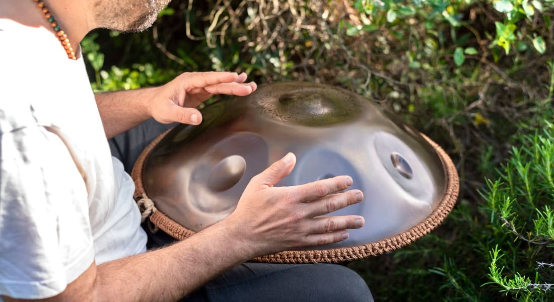 Back view of a handpan player