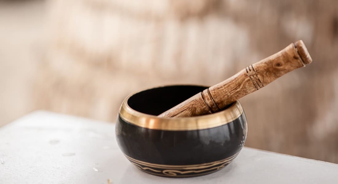 A black and gold Tibetan singing bowl