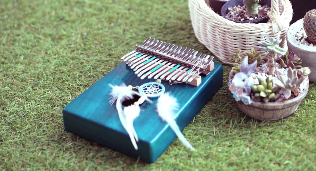 A blue kalimba with a dreamcatcher