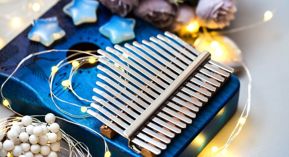 A blue kalimba with string lights