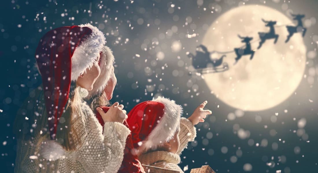 Children watching Santa Claus in the sky